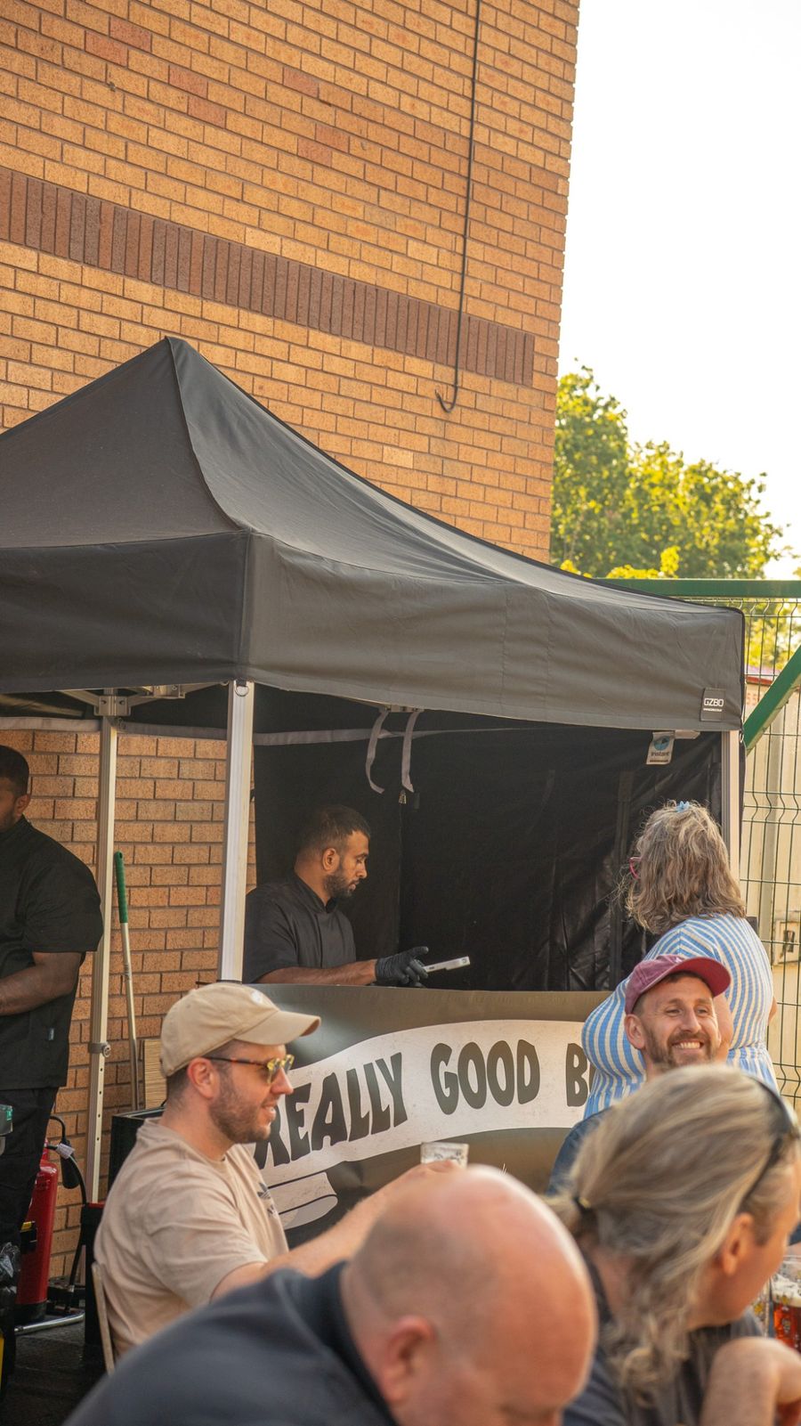 Really Good Burgers gazebo serving a busy outdoor crowd